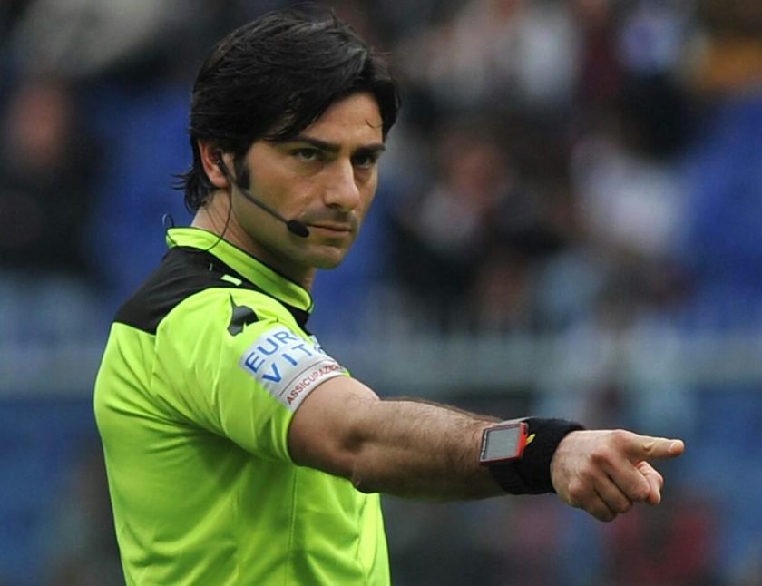 L'arbitro Fabio Maresca estrae un cartellino giallo con espressione severa
