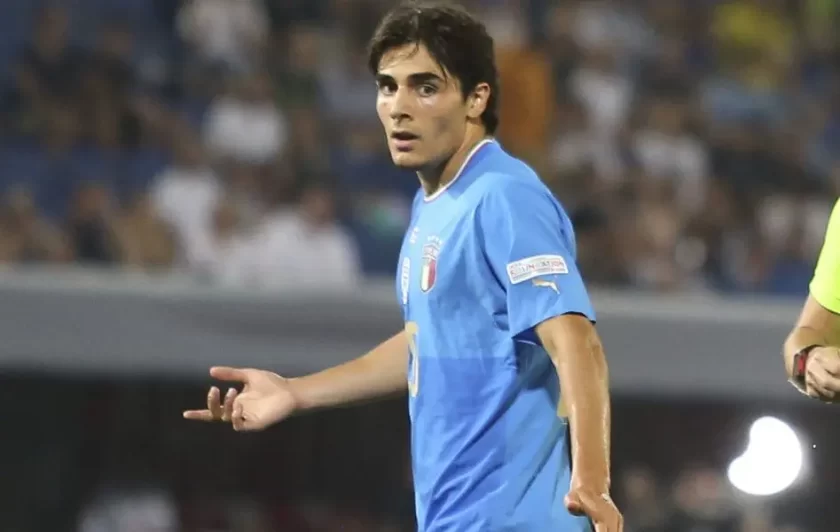 Una foto del giocatore Matteo Cancellieri con la maglia della Lazio, sorridente, durante un'intervista o un allenamento.